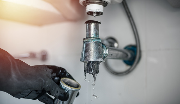 A person cleaning clogged drain