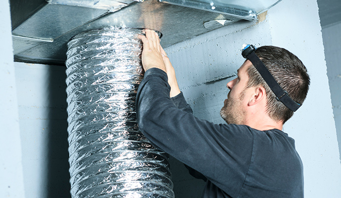 A professional installing air duct