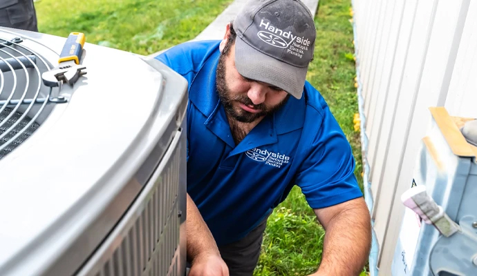 A professional of Handyside Plumbing, HVAC & Electrical repairing AC