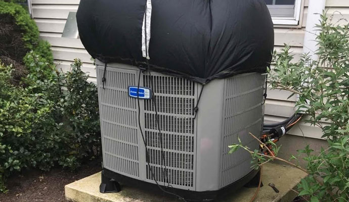 American Standard outdoor AC unit with protective weather cover