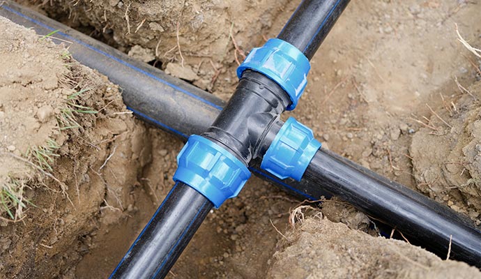 Underground sewer pipe installation and main line connection.