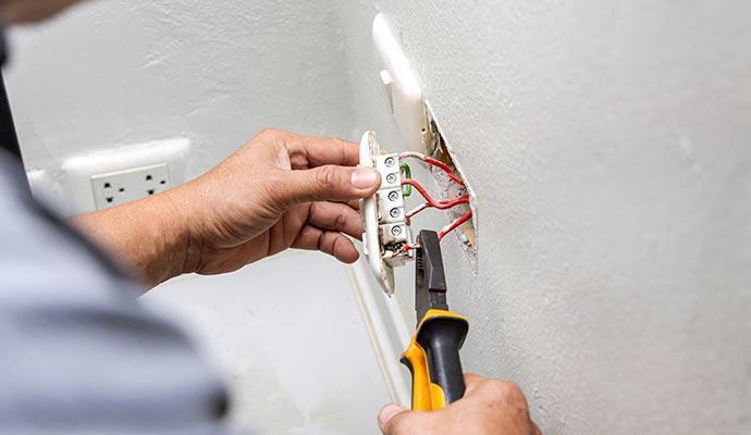 Electrician repairing electrical switch.