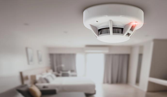 Smoke detector installed on bedroom ceiling.