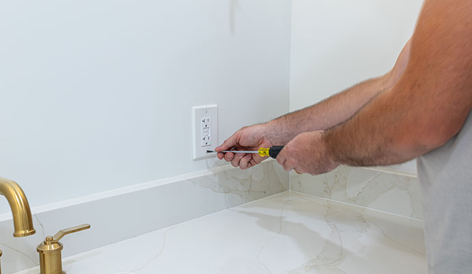 Electrician installing GFCI outlet