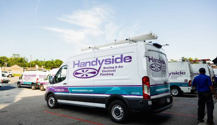 Handyside Plumbing, HVAC & Electrical service vehicles parked outdoors