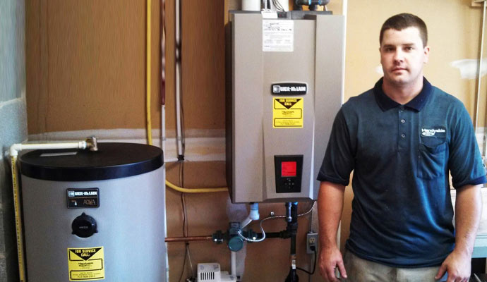 Handyside technician standing with an installed boiler