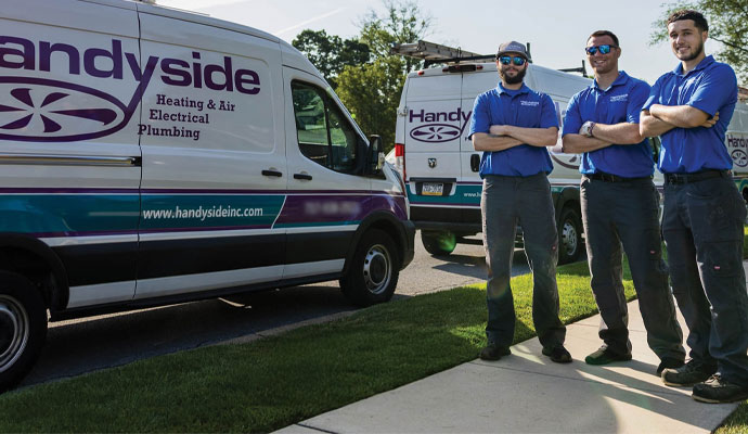 Professional Handyside HVAC service team with company vans.