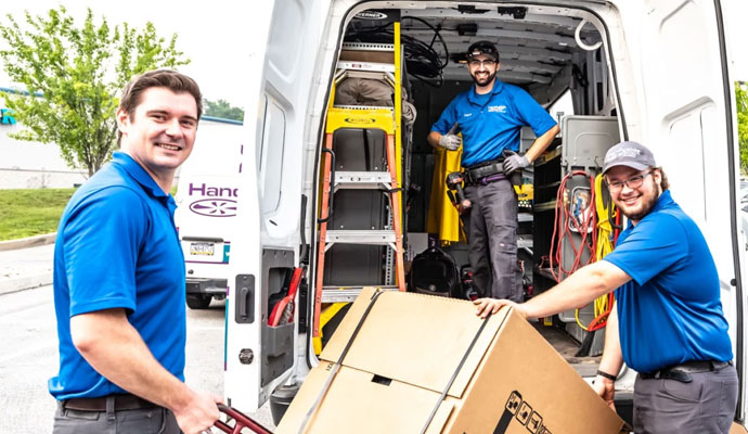 Professional team unloading heating system from a van