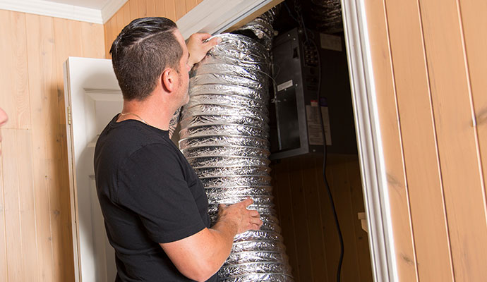 Technician inspecting residential air ducts for cleaning