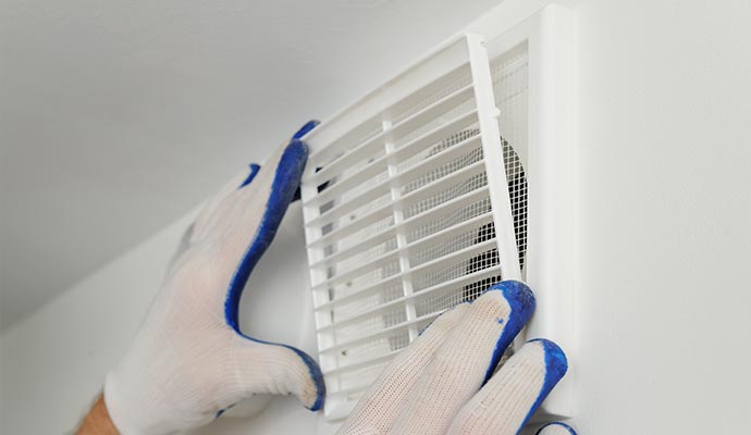 Installing exhaust fan ventilation grille on a wall