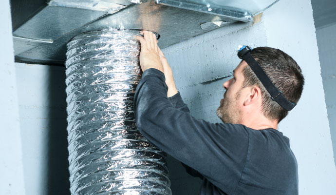 Technician replacing air duct vent