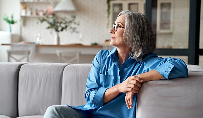 Woman relaxing on sofa at home