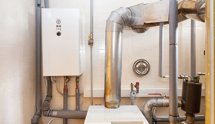 Modern oil boiler system and heating pipes in utility room