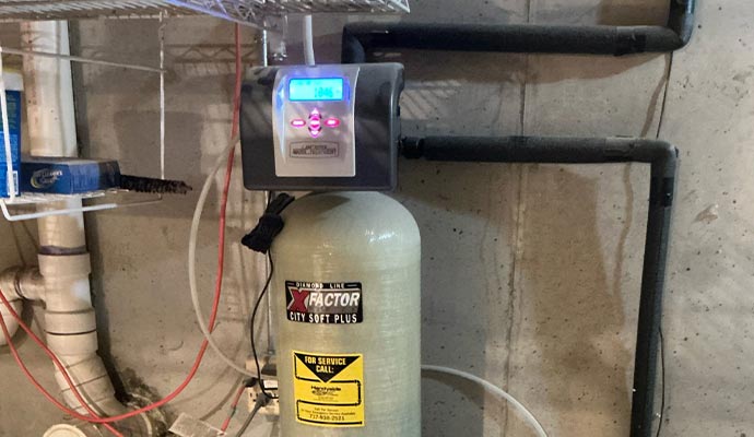 A professionally installed water softener tank with a digital interface