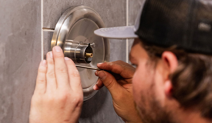Plumber repairing shower faucet