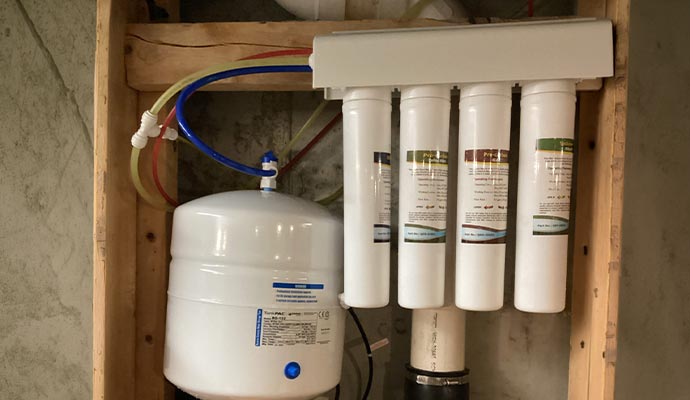 Residential reverse osmosis filtration system setup.