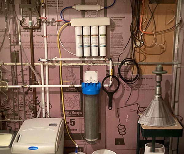 Reverse Osmosis water filtration system installed in a residential basement.