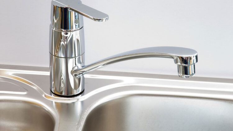 Shiny stainless steel sink and tap.