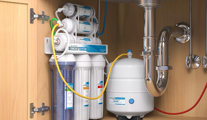 Under sink reverse osmosis filtration system installation in kitchen cabinets.