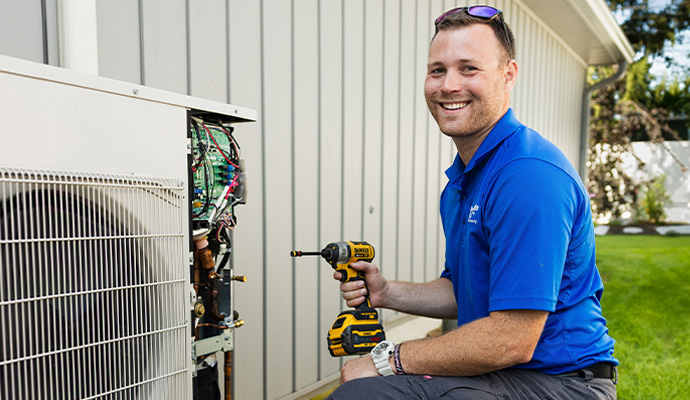 Professional repairing an outdoor HVAC unit
