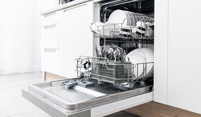 Repaired dishwasher filled with clean dishes