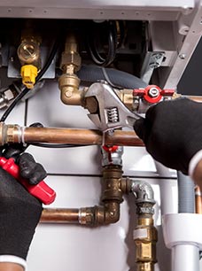 Professional repairing complex copper plumbing pipes.