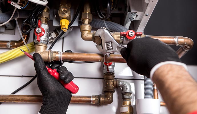 Professional repairing complex copper plumbing pipes.