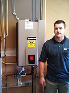 Professional technician standing by a home boiler system.