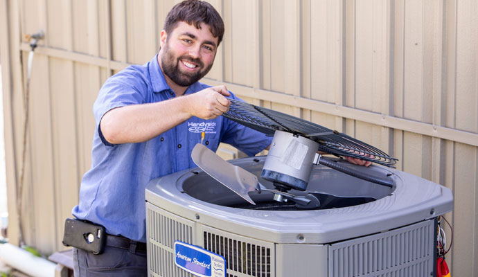 Technician repairing outdoor ac unit