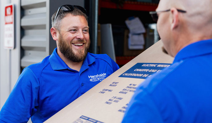 Technicians carrying a water heater for installation